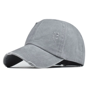 Detail of grey washed cotton baseball cap featuring vintage distressing and side embroidery