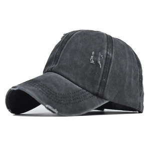 Detail of distressed dark grey washed cotton baseball cap with frayed edges and stitching