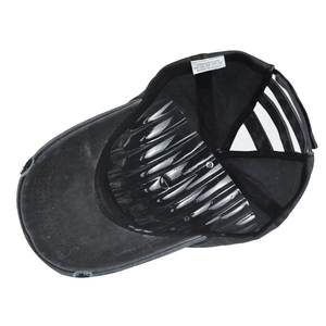 Detail of washed cotton ponytail baseball cap featuring distressed brim and fabric tag