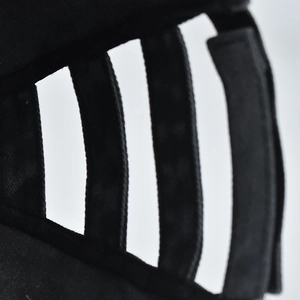 Detail of adjustable black fabric straps on a washed vintage ponytail baseball cap