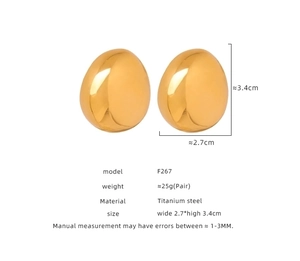 Detailed view of large gold-plated oval titanium steel earrings with high-polish finish