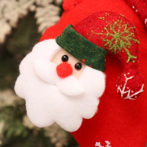 Close-up of felt Santa Claus patch with red and green embroidery on Christmas stocking