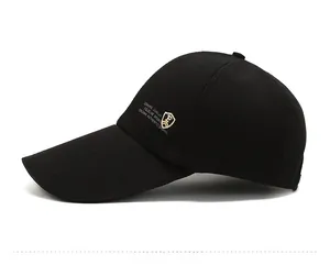 Detail showing the extended brim and side shield logo on the black baseball cap