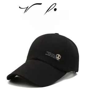 Close-up of black baseball cap featuring detailed white embroidery and reinforced stitching