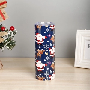 Detailed view of 20oz Christmas tumbler with Santa Claus patterns on a wooden surface