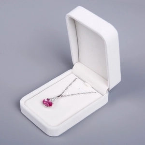 Detailed view of an elegant pink gemstone necklace in a white velvet jewelry gift box