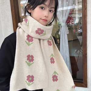 Close-up detail of soft beige knitted floral pattern scarf worn by an Asian female model