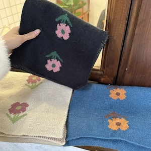 Knitted winter scarf in black beige and blue with floral patterns and soft cashmere feel
