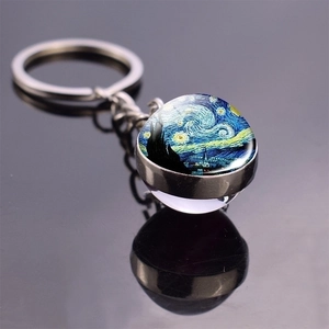 Detailed macro shot of glass dome keychain featuring Van Gogh's Starry Night artwork
