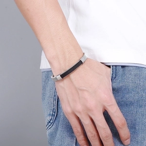 Men's minimalist black woven leather bracelet with silver stainless steel clasp on wrist