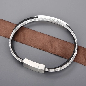 Detail of silver mesh weave and black leather strap with magnetic clasp
