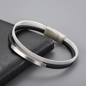 Detail of silver mesh and black leather bracelet with polished magnetic steel clasp