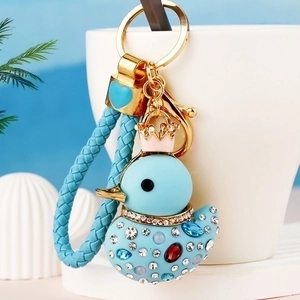 Detail of blue crown duck keychain featuring sparkling rhinestones and woven strap