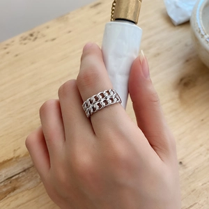 Detail of minimalist 925 sterling silver double Cuban chain ring worn on a finger