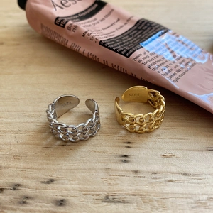 Close-up of dual chain link S925 sterling silver rings in gold and silver finishes