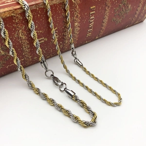Macro detail of two-tone gold and silver rope chain necklaces with lobster clasp