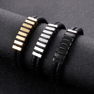 Close-up of men's leather braided bracelets with metal accents in gold, silver and black