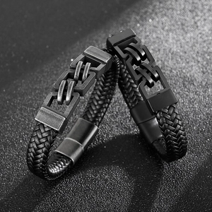 Detail of woven leather bracelets with vintage silver and matte black metal clasps