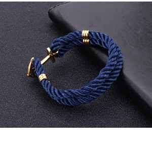 Detail of navy blue braided nylon rope bracelet with golden stainless steel anchor clasp