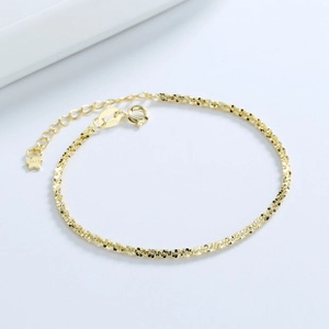 Detail of S925 sterling silver gold bracelet with adjustable chain and star charm