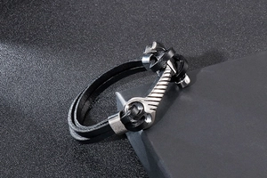 Detail of multi-layer black leather wrap bracelet with silver stainless steel hammer clasp