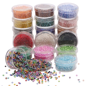 Macro shot of 2mm silver-lined glass seed bead assortment in a clear storage organizer