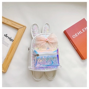 Detail of white sequin backpack featuring rabbit ears and a large pink decorative bow