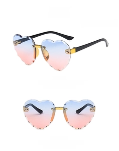 Detail of rimless heart-shaped sunglasses with blue-pink gradient lenses for kids
