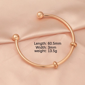 Detail view of 60.5mm rose gold stainless steel open bangle with bead accents