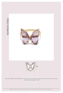 Detailed view of butterfly ring with purple crystal glass and gold plating specs