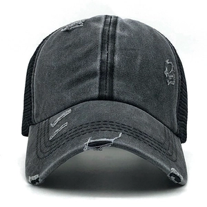 Close-up of distressed grey baseball cap with vintage washed fabric and mesh back