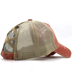 Detail of the elastic criss-cross ponytail hole and mesh back on the baseball cap