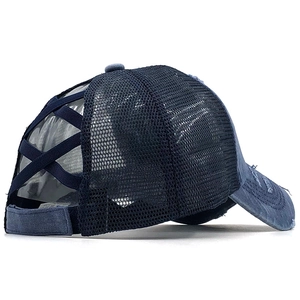 Detail of dark blue ponytail baseball cap featuring cross elastic bands and mesh