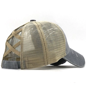Detail of cross elastic ponytail bands on a distressed mesh baseball cap back