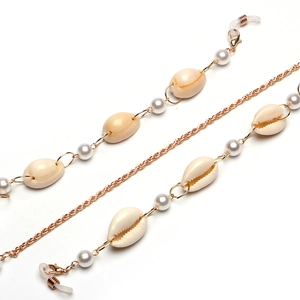 Chaîne de lunettes dorée avec coquillages blancs et perles sur fond minimaliste