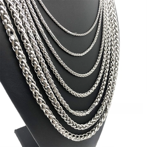 Macro shot of silver stainless steel wheat chain necklaces in various thickness levels
