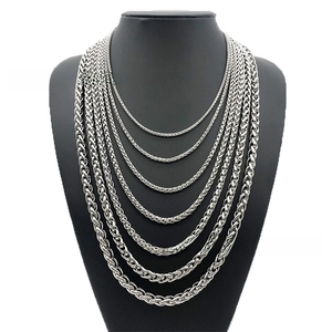 Detail of stainless steel wheat and foxtail chains in seven different sizes on neck model