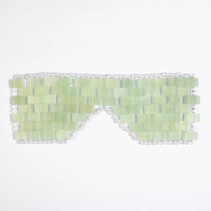 Handcrafted light green natural jade eye mask made of woven jade stones on white background