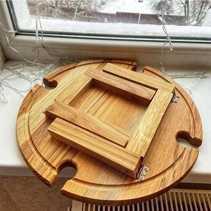 Foldable circular wooden picnic wine table with four glass holder slots and light grain
