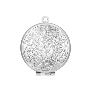 Close-up of a silver round stainless steel locket pendant with embossed floral patterns