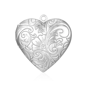 Detail of silver heart-shaped locket with vintage floral engravings and metal finish