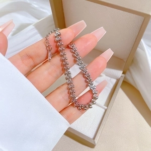 S925 sterling silver wheat ear chain bracelet held in a hand over a jewelry box