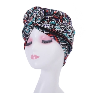 Front view of turban hat with geometric ethnic pattern on white mannequin head