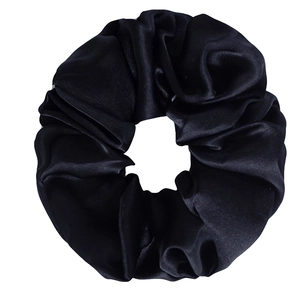 Detailed close-up of a premium black mulberry silk scrunchie with soft satin shine and texture