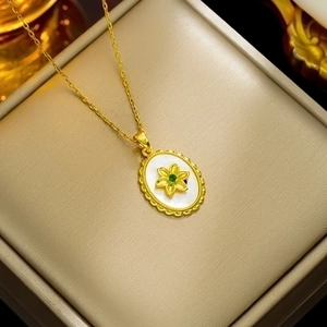 18K gold-plated oval necklace with white mother-of-pearl, gold flower, and green gem detail