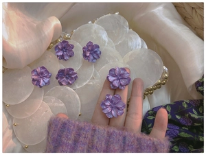 Detailed view of handmade purple gardenia flower earrings with delicate pearl luster