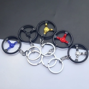 Zinc alloy car steering wheel keychains in five colors on a black and white background