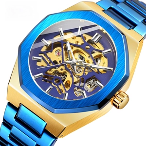 Close-up of golden octagonal case and blue bezel on skeleton automatic mechanical watch