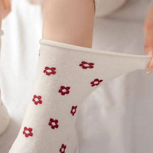 Milk white cotton crew socks with red floral pattern and elastic rolled cuff detail