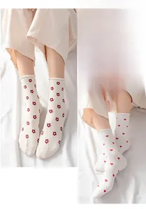 Detailed view of floral and heart pattern cotton mid-calf socks with cute rolled edges